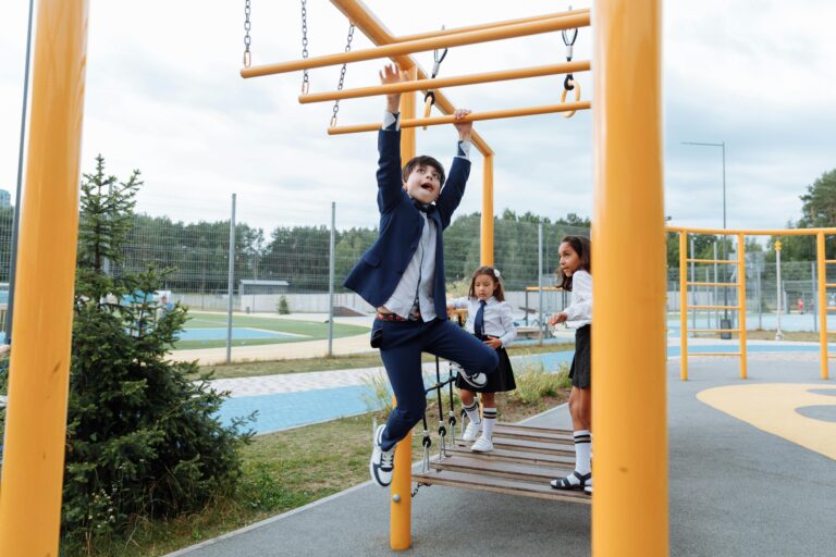 Kids having fun and playing on monkey bars in school playground. Bright and engaging scene of childhood activity.